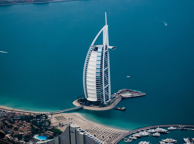 Dubai: An aerial of the sail-shaped Burj Al Arab on its island, ringed by turquoise Gulf water and a marina