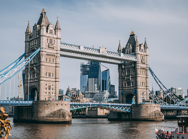 London: Tower Bridge from the north bank of the Thames, with the glass towers of the City rising behind it