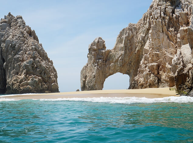 Los Cabos: El Arco, the natural rock arch at Land’s End, rising from pale sand and clear turquoise water