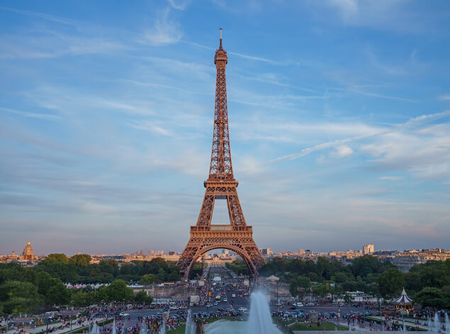 Paris: The Eiffel Tower from the Trocadéro, gardens and crowds below under a broad blue sky