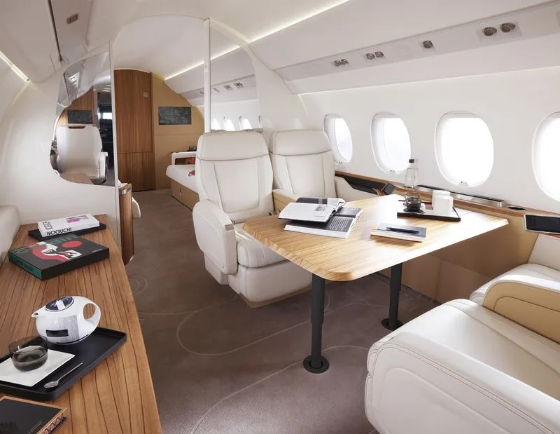 Private jet cabin with a work table and club seats
