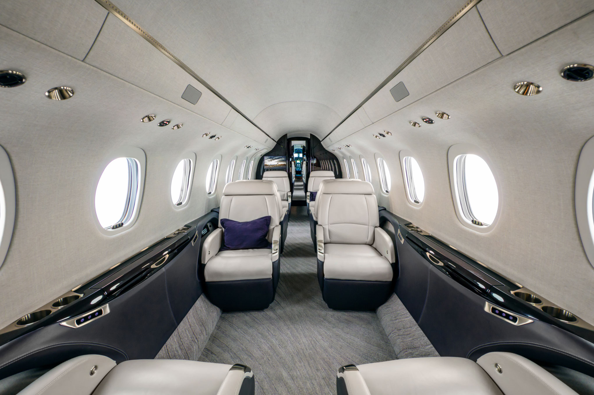 Cessna Citation Longitude cabin aisle with cream leather club seats