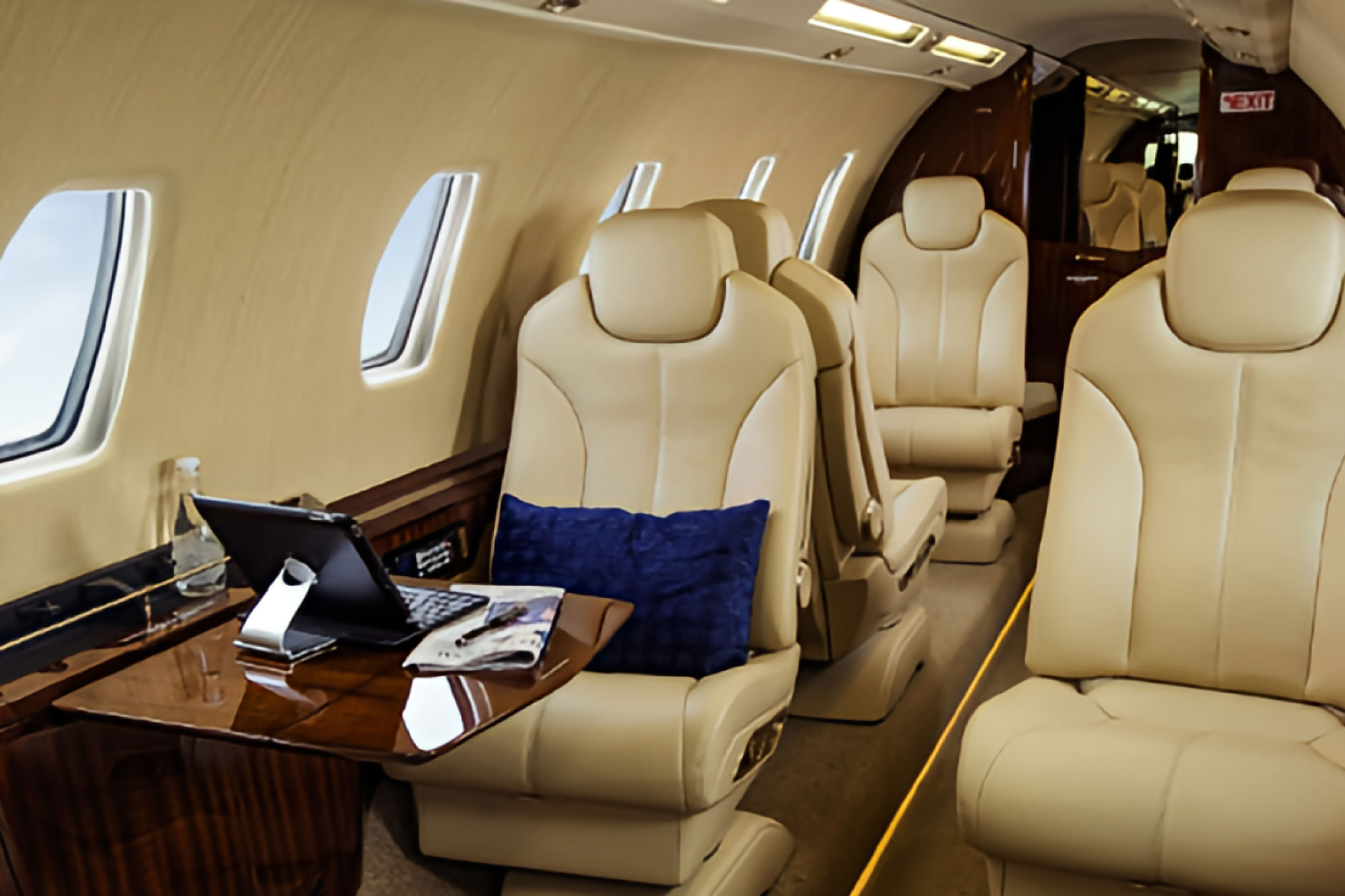 Cessna Citation Sovereign+ cabin with tan leather club seats and a work table