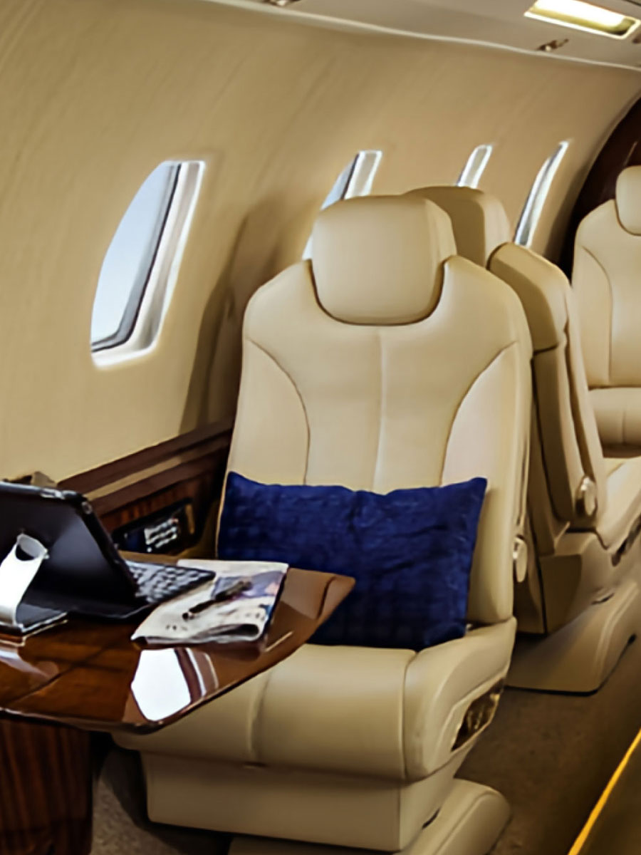Cessna Citation Sovereign+ tan leather cabin seat with work table, portrait view