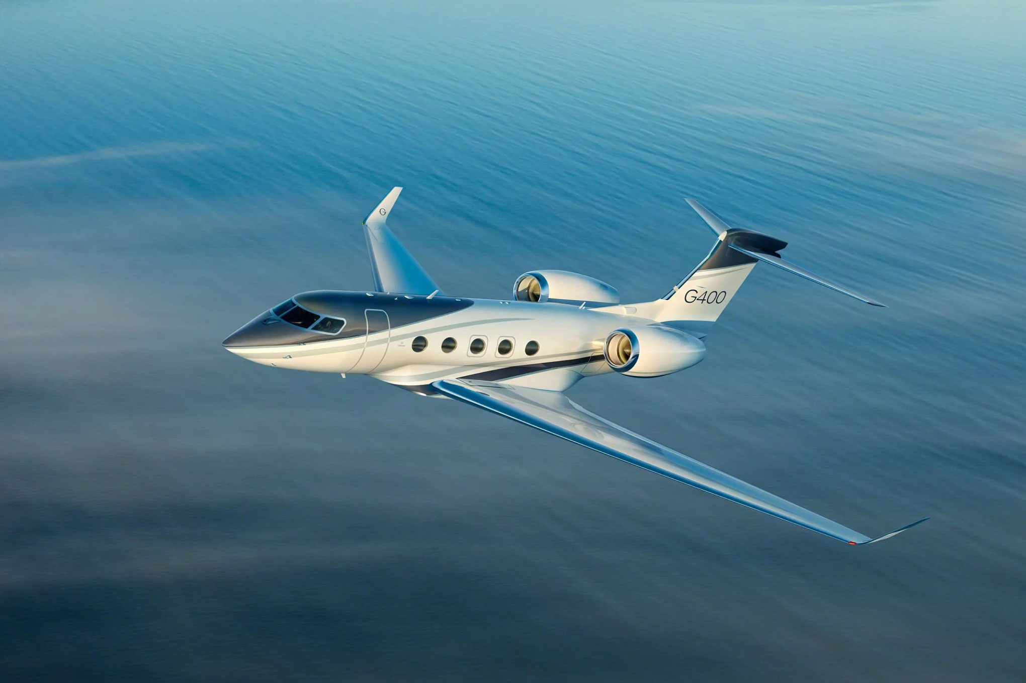 Gulfstream G400 in flight low over open water