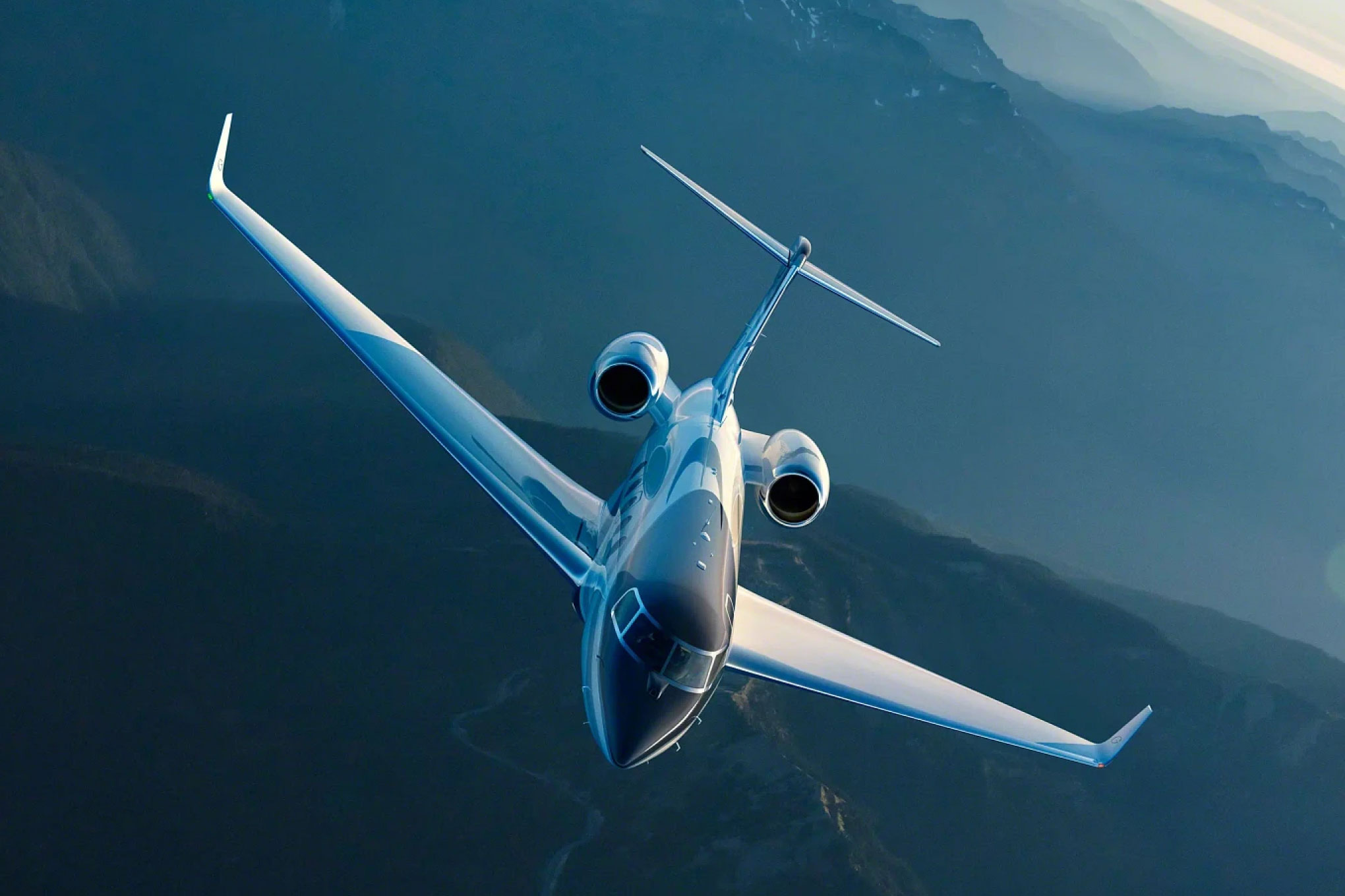 Gulfstream G400 banking over mountain terrain