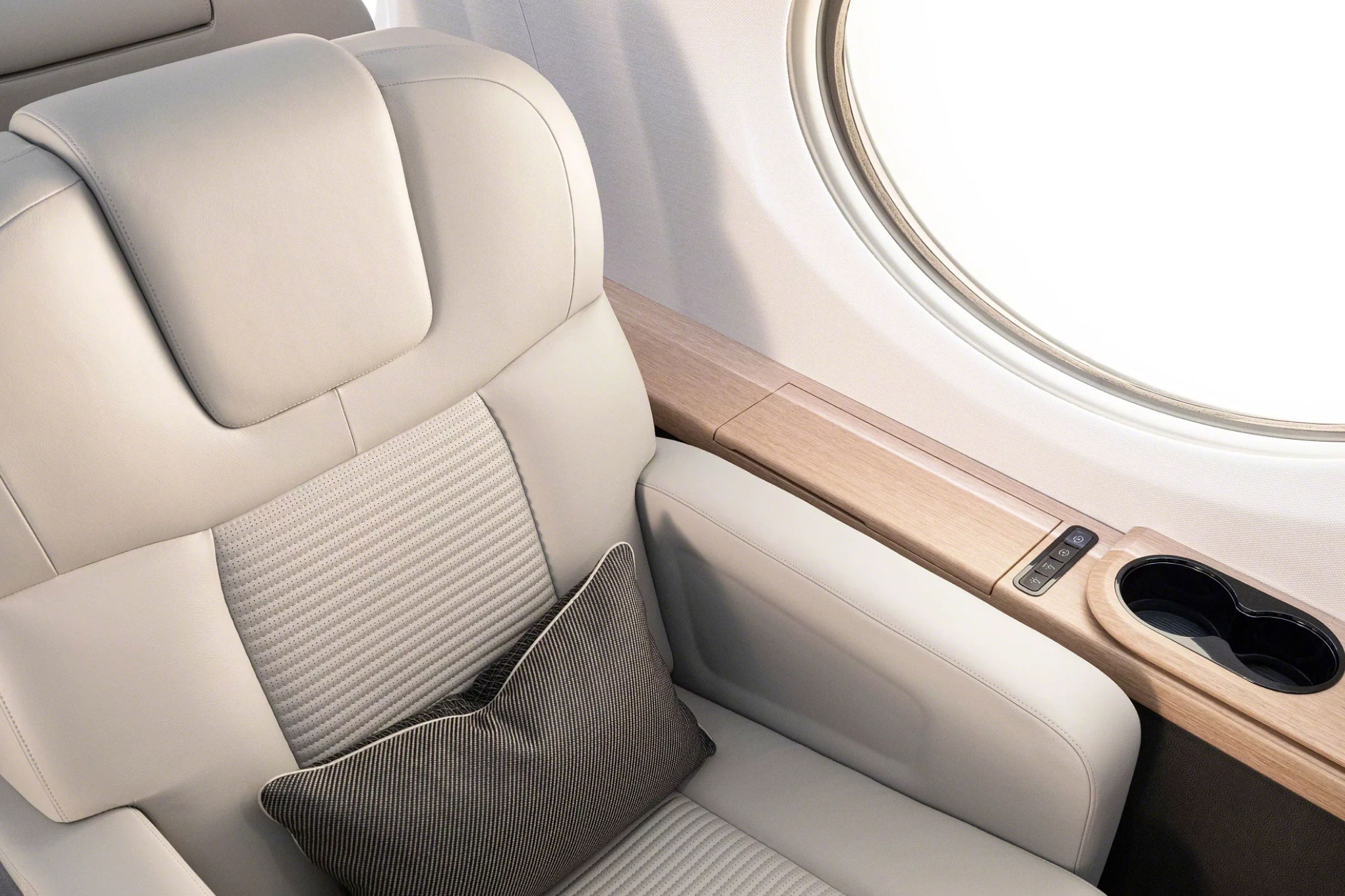 Gulfstream G400 leather club seat beside an oval window