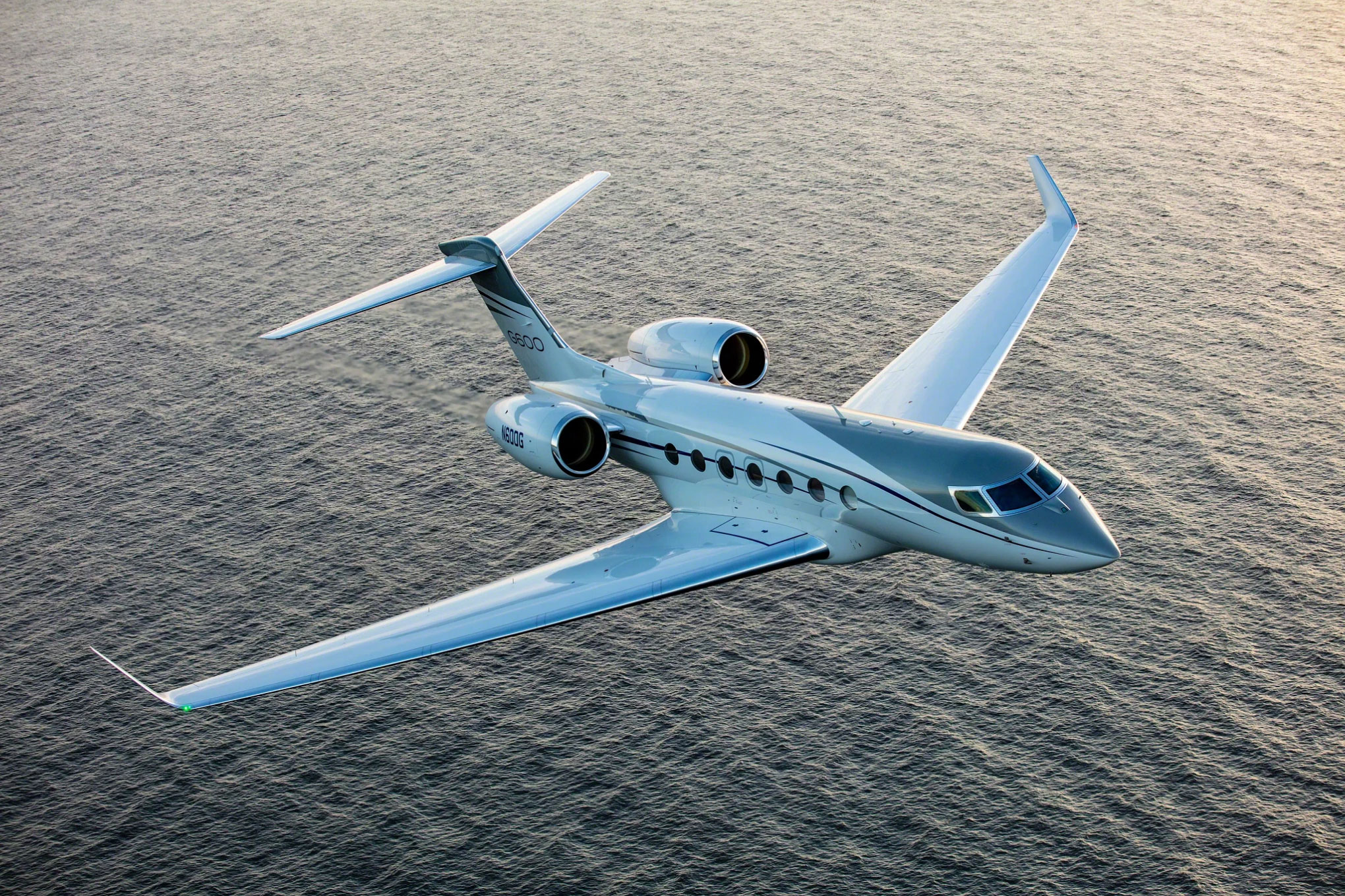Gulfstream G600 in flight low over the sea