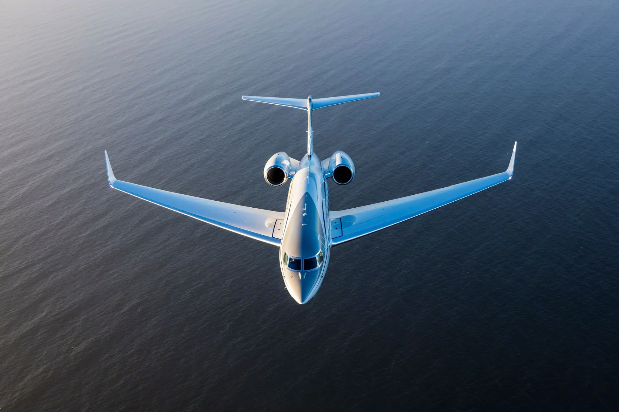 Gulfstream G650 in flight over the ocean, head-on