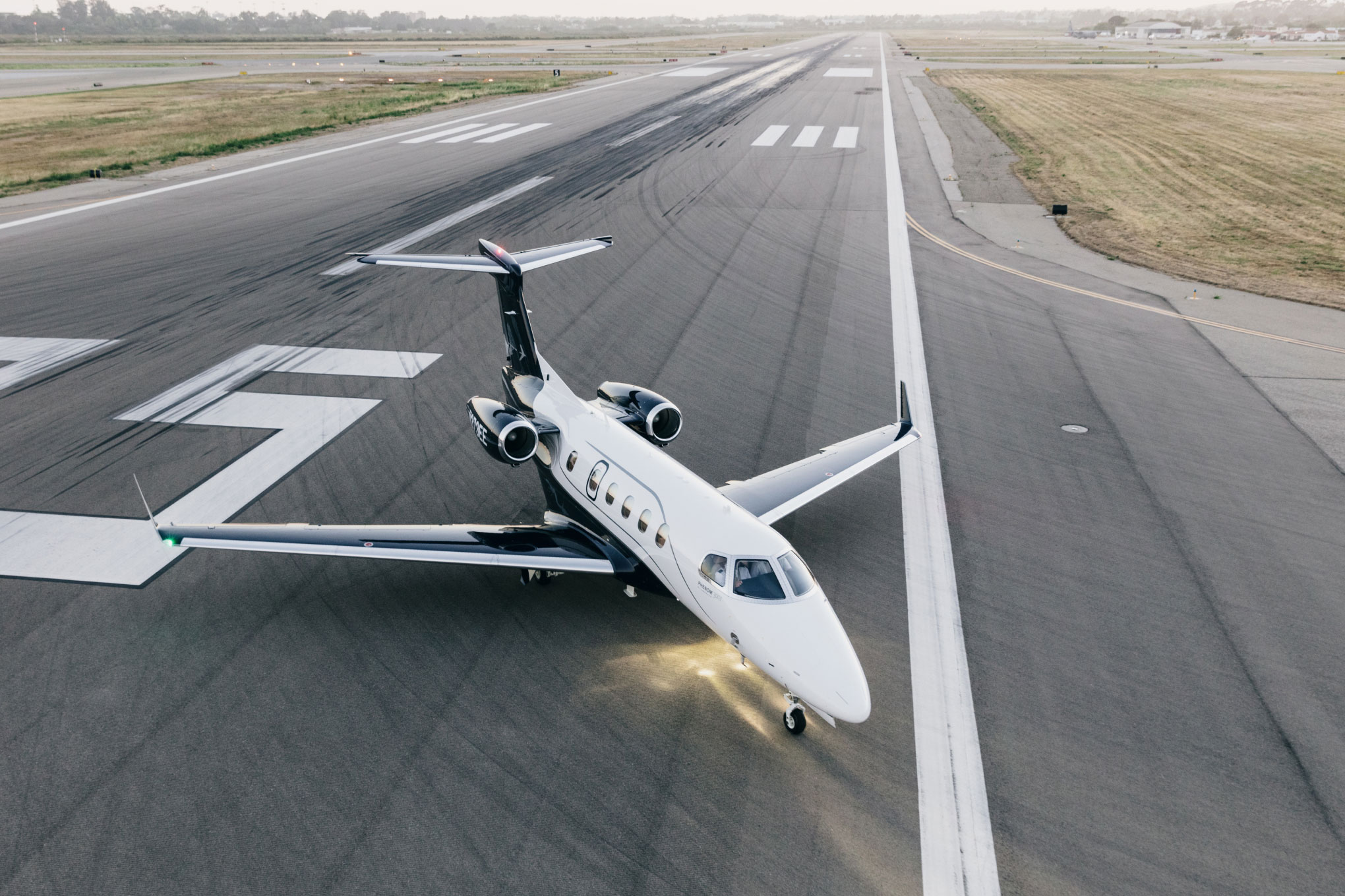 Embraer Phenom 300E on the runway at takeoff