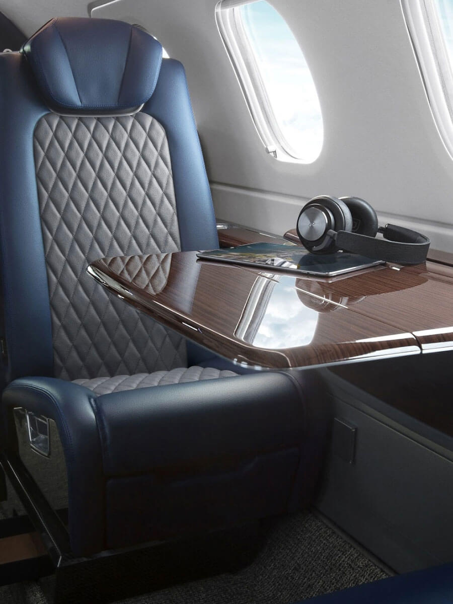 Embraer Phenom 300E quilted navy leather seat and table, portrait view
