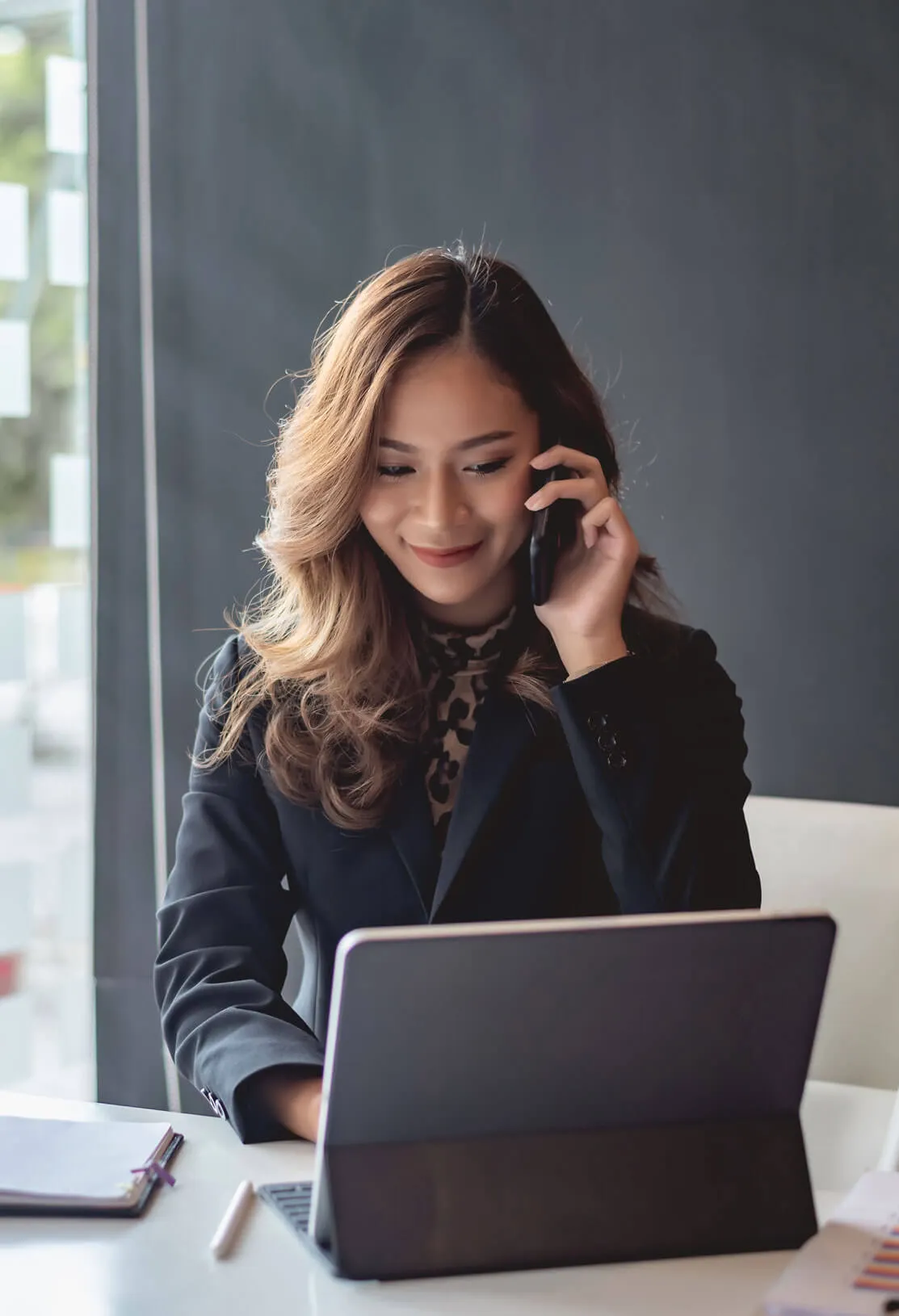 Concierge on the phone at a laptop arranging pet travel