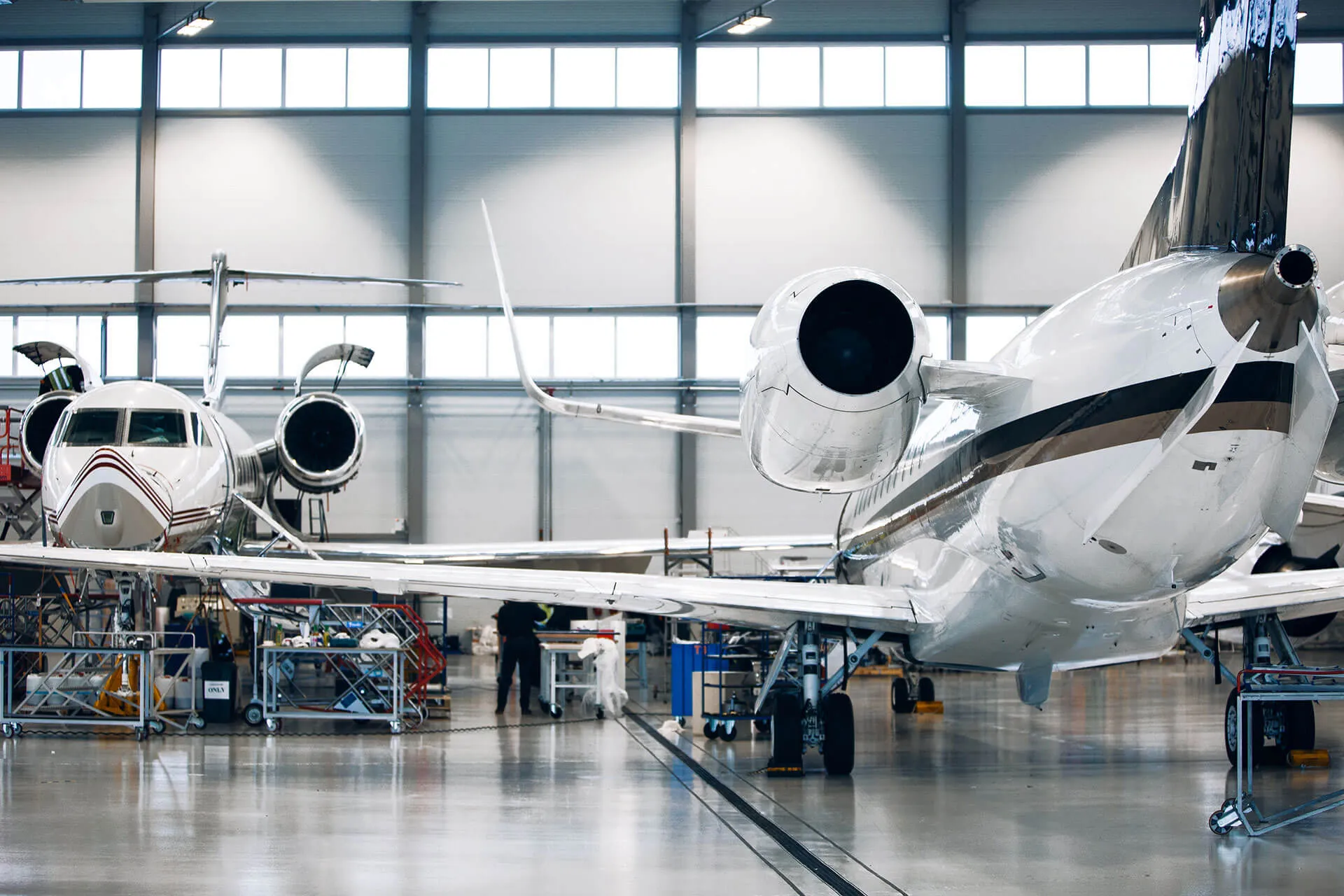 Managed private jets parked in a maintenance hangar